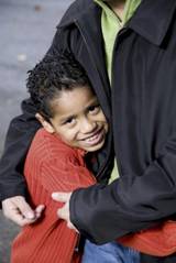 Latino boy in man's arms