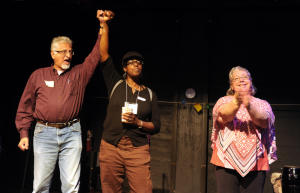 Newly elected Richmond City Council member Eduardo Martinez and council member Jovanka Beckles join hands while council member Gayle McLaughlin applauds