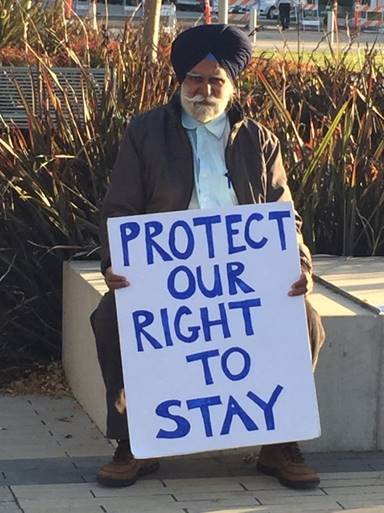 A supporter of an emergency moratorium on rents waits outside Richmond City Hall Tuesday.