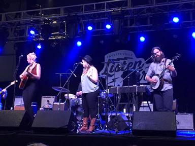 Image may contain: 1 person, on stage, playing a musical instrument, concert and indoor