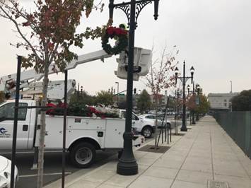Macdonald and 12th install holiday ornaments
