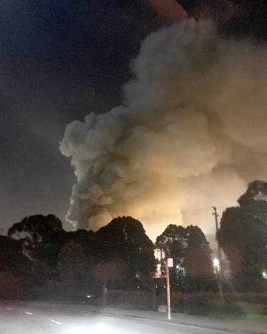 Smoke is seen coming from the Sims Metal Management property in this view from Cutting Boulevard as a scrap metal fire burns Richmond, Calif., on Tuesday, Jan. 30, 2018. Smoke was visible for miles and authorities warned residents to stay indoors. (Courtesy of Henna Papineau)