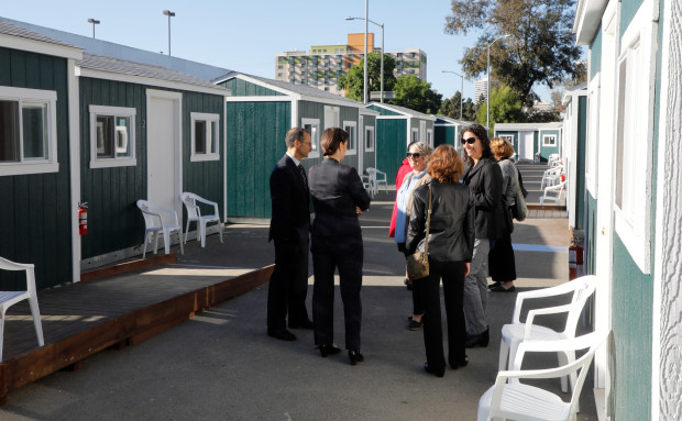 City officials and community members tour the newest Tuff Sheds community at Northgate Avenue and 27th Street in Oakland, Calif., on Monday, May 7, 2018. This is the second Tuff Sheds community opening to address the homeless crisis. (Laura A. Oda/Bay Area News Group)
