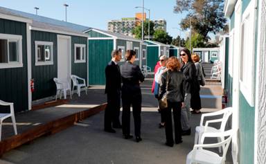 City officials and community members tour the newest Tuff Sheds community at Northgate Avenue and 27th Street in Oakland, Calif., on Monday, May 7, 2018. This is the second Tuff Sheds community opening to address the homeless crisis. (Laura A. Oda/Bay Area News Group)