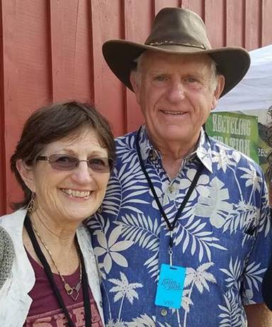 Image may contain: 3 people, including Tom Butt, people smiling, people standing, hat and outdoor