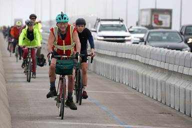 Bicyclists complete their inaugural ride across the Richmond-San Rafael Bridge after the new bike and pedestrian path on the span opened to the public.