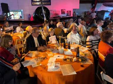 Image may contain: 2 people, people sitting, table and indoor