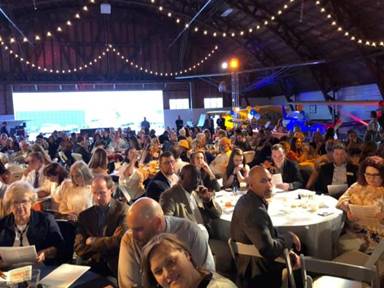 Image may contain: 3 people, people smiling, crowd and indoor