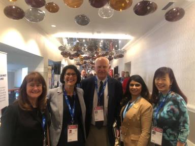 Image may contain: 5 people, including Tom Butt, people smiling, people standing and indoor
