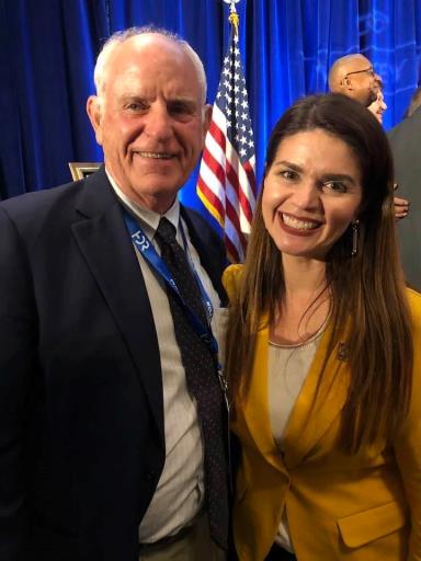 Image may contain: 2 people, including Tom Butt, people smiling, people standing and suit