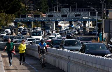 Traffic funnels into two westbound lanes after passing through the toll plaza and past a recently opened bicycle and pedestrian path on the Richmond-San Rafael Bridge.