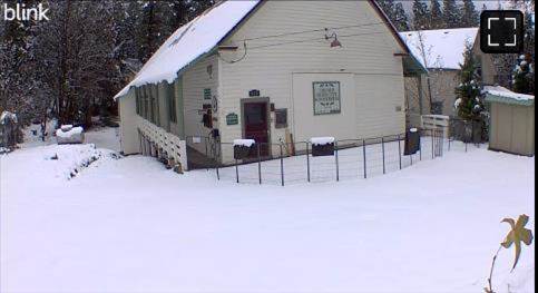A house with snow on the ground Description automatically generated