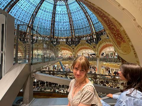 A person standing in a large glass dome Description automatically generated