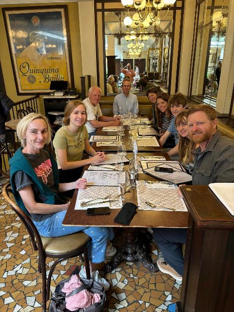 A group of people sitting at a table Description automatically generated