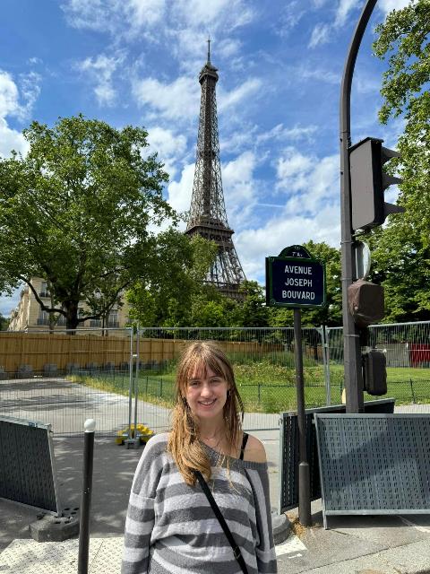 A person standing in front of a tower Description automatically generated