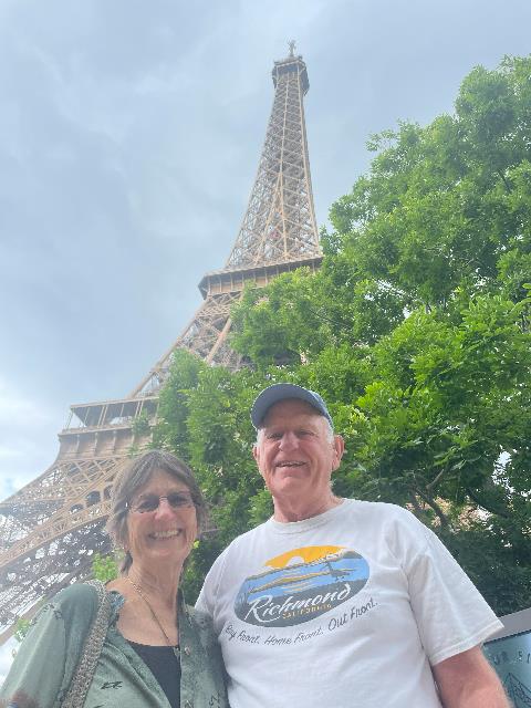 A person and person standing in front of a tower Description automatically generated