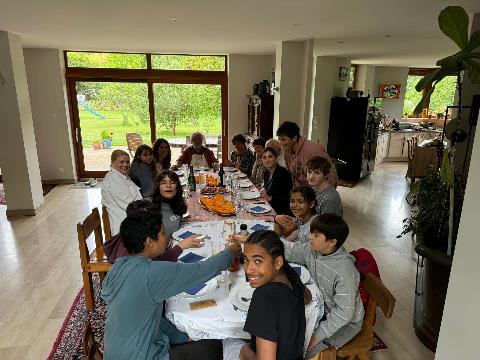 A group of people around a table Description automatically generated